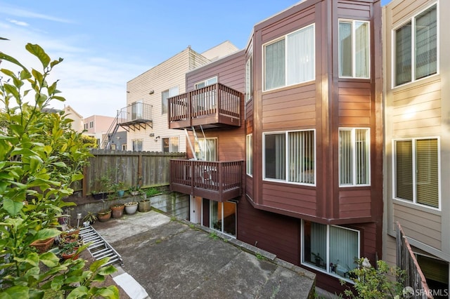 rear view of property featuring fence and a residential view