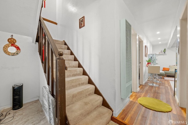 staircase with recessed lighting, baseboards, and hardwood / wood-style floors