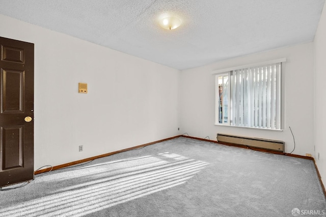 carpeted empty room featuring baseboard heating, baseboards, and a textured ceiling