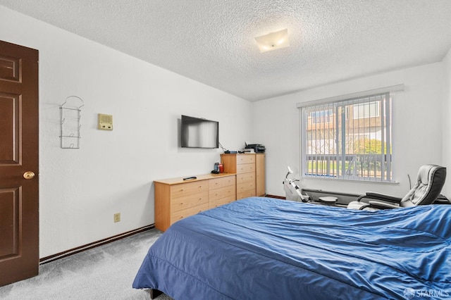 bedroom featuring carpet, a textured ceiling, and baseboards