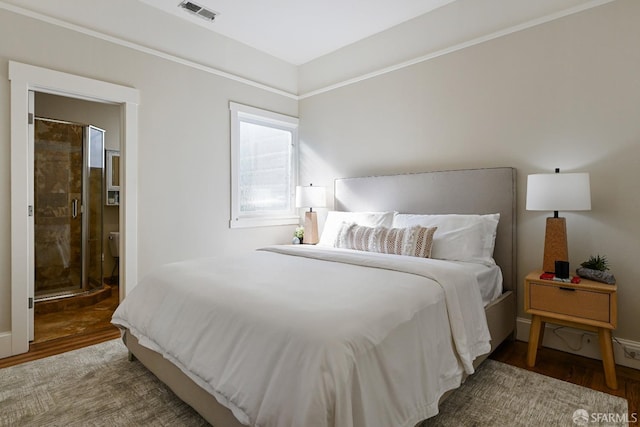 bedroom with visible vents and wood finished floors
