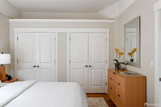 bedroom with dark wood finished floors