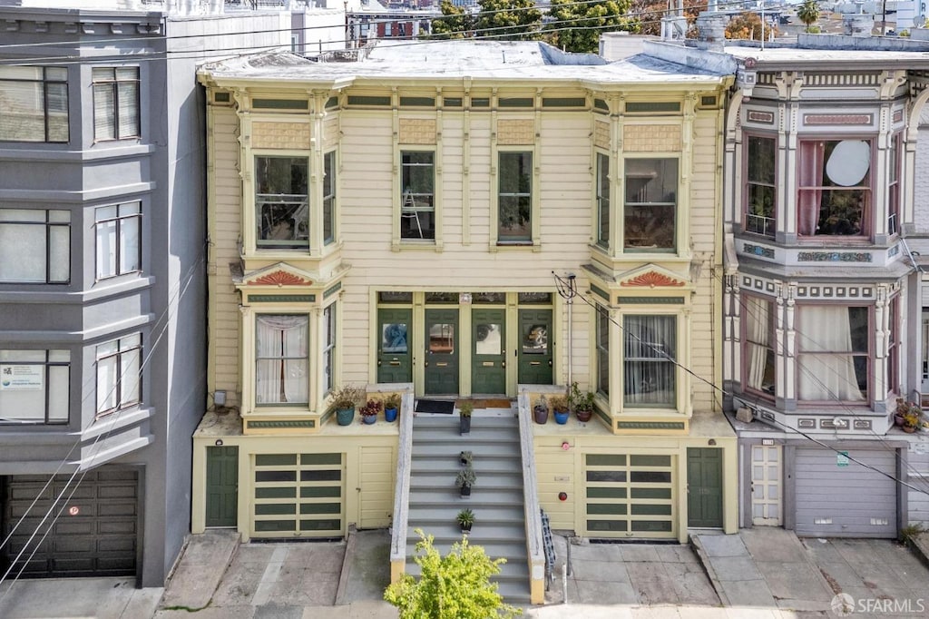 113-115 Bartlett St, San Francisco, CA 94110 - view of front of house featuring driveway and an attached garage