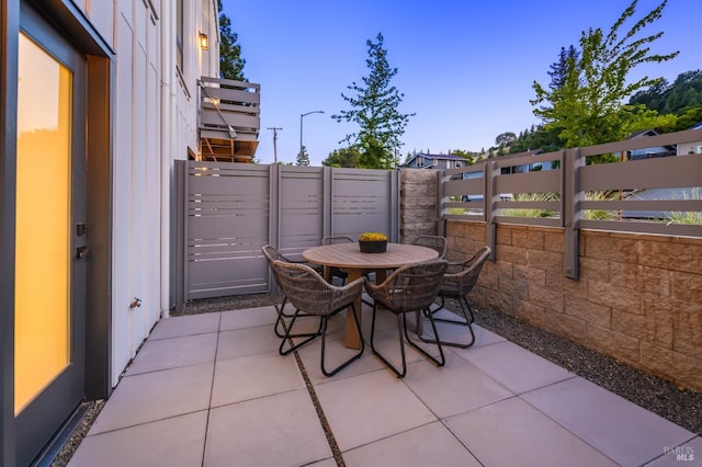 view of patio featuring fence and outdoor dining space