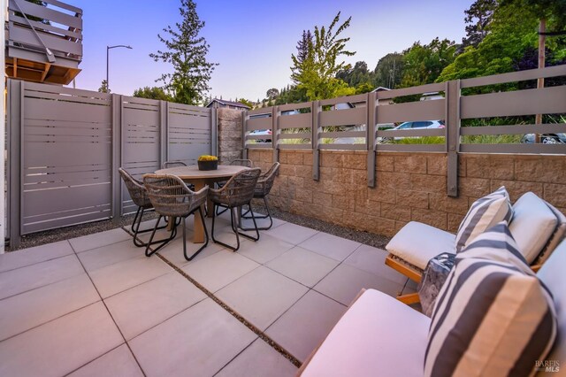 view of patio / terrace with outdoor dining area and fence