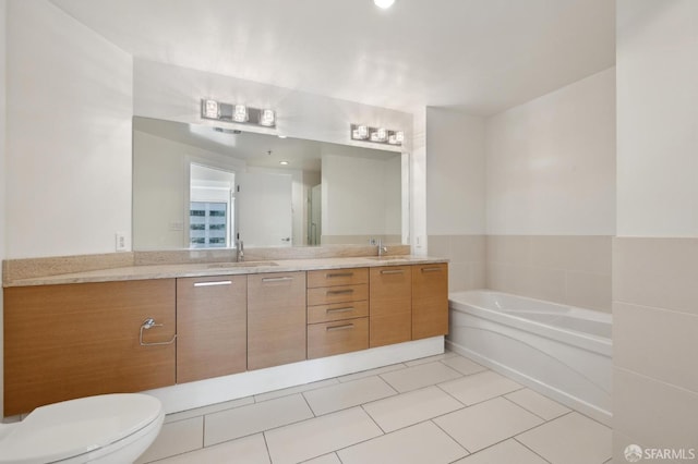 bathroom featuring a sink, a garden tub, double vanity, and tile patterned floors