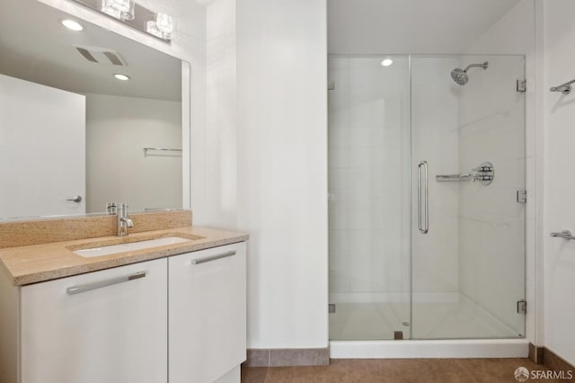 full bathroom with vanity, visible vents, tile patterned flooring, and a stall shower