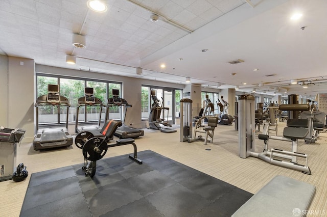 gym with rail lighting, carpet flooring, recessed lighting, and visible vents