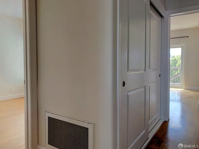 corridor with hardwood / wood-style flooring