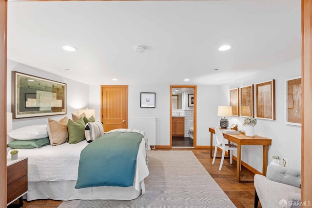 bedroom featuring ensuite bathroom and light hardwood / wood-style flooring