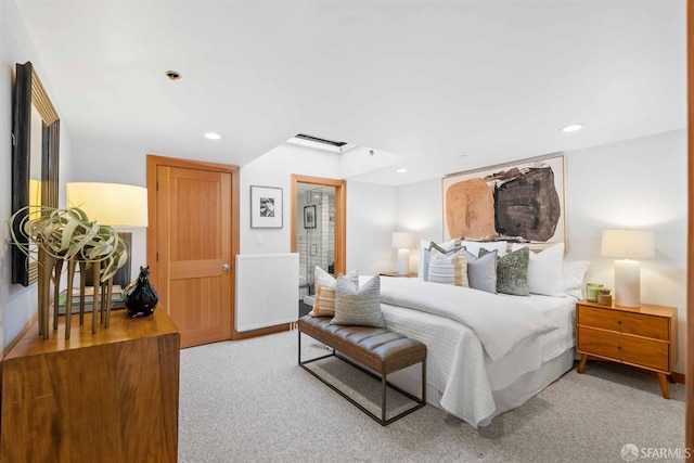 bedroom featuring light colored carpet and radiator