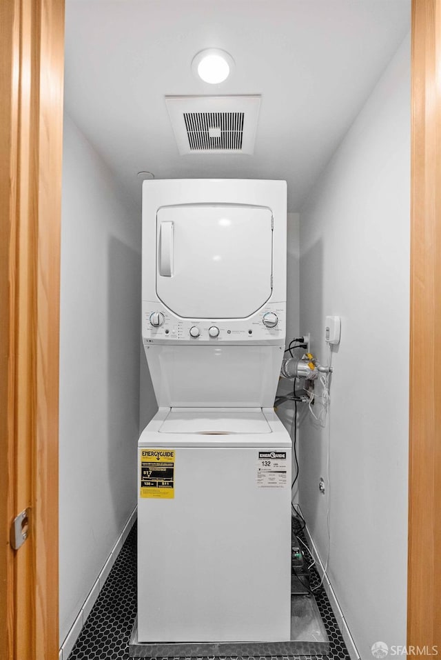 laundry area with stacked washer and clothes dryer