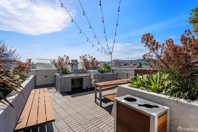 view of patio featuring an outdoor fire pit, a grill, and an outdoor kitchen