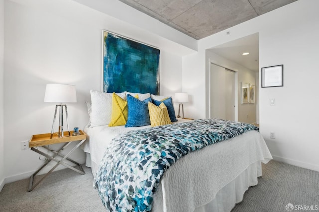 bedroom with a closet, baseboards, and carpet floors