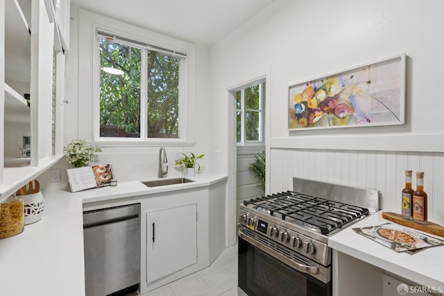 1250 Vallejo St Unit 8, San Francisco, CA 94109 - kitchen featuring stainless steel appliances, light countertops, light tile patterned floors, and white cabinets