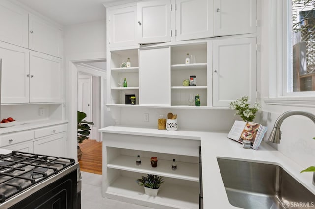 1250 Vallejo St Unit 8, San Francisco, CA 94109 - kitchen with open shelves, white cabinetry, light countertops, and gas range oven