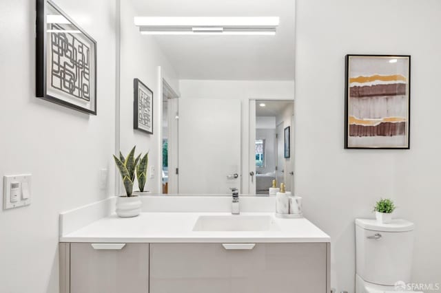 bathroom with toilet and vanity