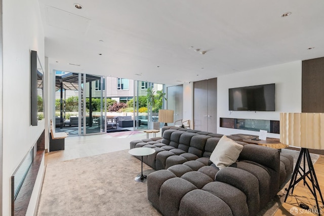 living room with expansive windows and wood finished floors