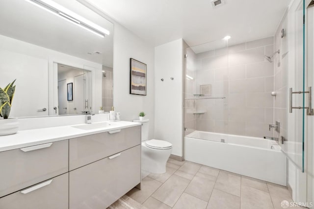 bathroom with visible vents, shower / bath combination, toilet, vanity, and tile patterned floors