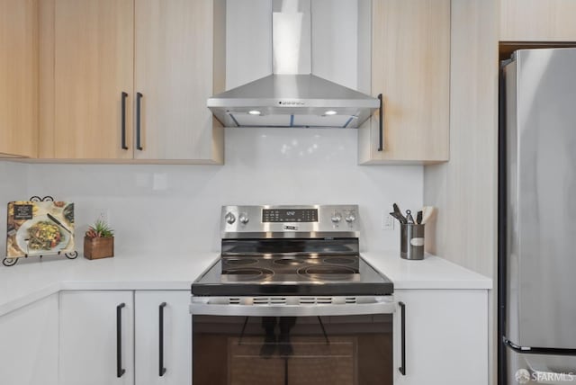 kitchen with stainless steel appliances, wall chimney exhaust hood, tasteful backsplash, and light brown cabinets