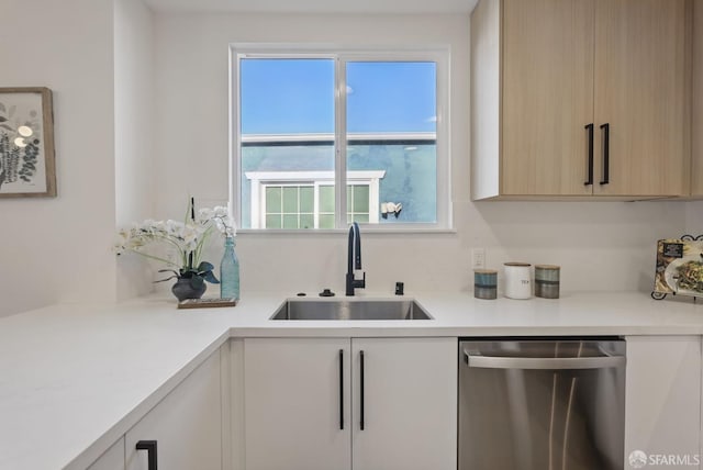 kitchen with sink, light brown cabinetry, and dishwasher