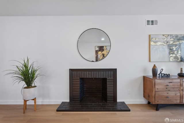 room details with wood-type flooring and a fireplace