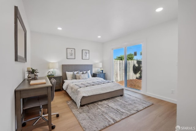 bedroom with access to outside and light hardwood / wood-style floors