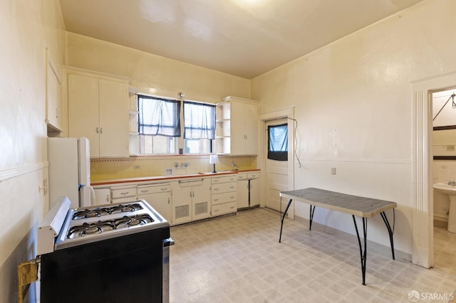 kitchen with tasteful backsplash, light floors, white appliances, and white cabinets