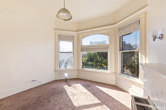 carpeted empty room with baseboards