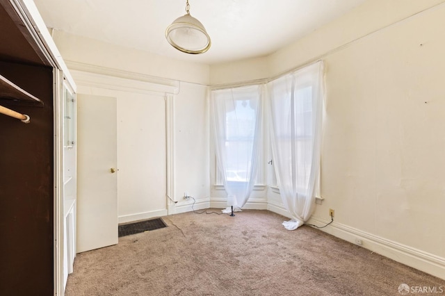 unfurnished bedroom featuring carpet floors and baseboards