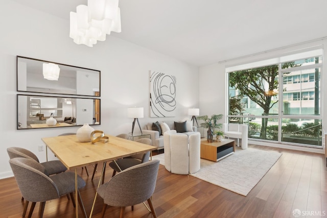 living room with an inviting chandelier and wood finished floors