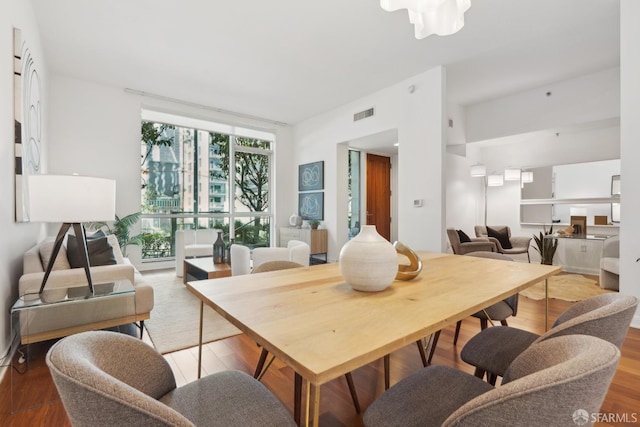 dining area featuring visible vents and wood finished floors