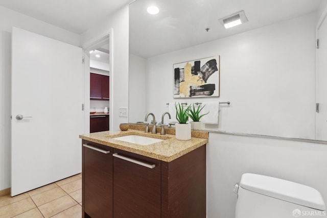 bathroom with vanity, tile patterned floors, toilet, and visible vents