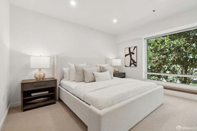 bedroom with recessed lighting, baseboards, and light colored carpet