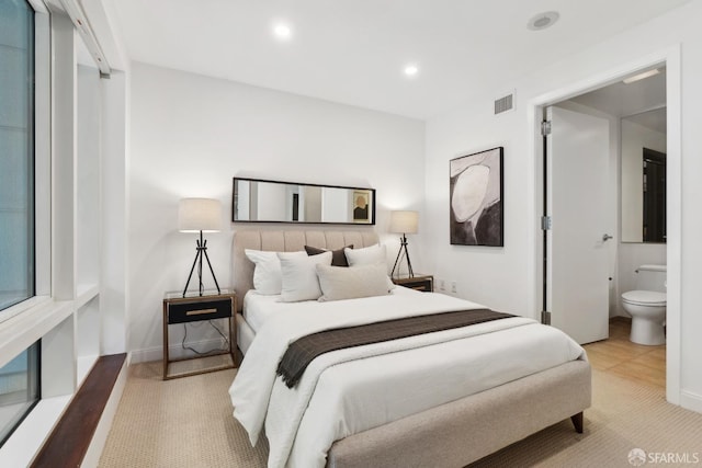 bedroom with recessed lighting, visible vents, and ensuite bathroom