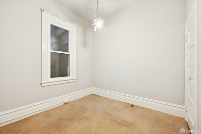 unfurnished room featuring baseboards