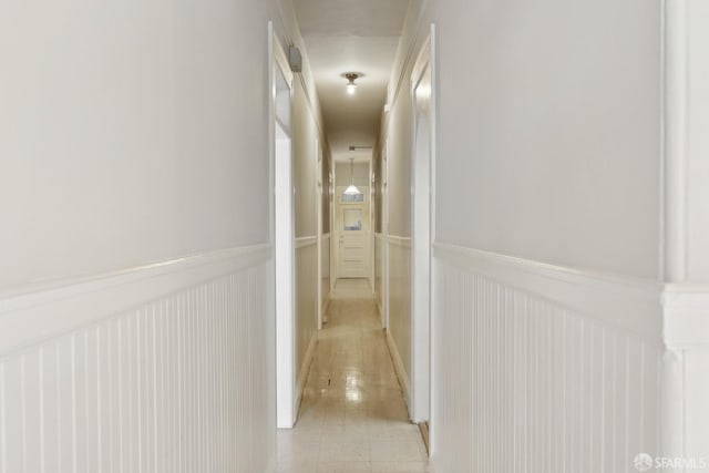 hallway featuring a wainscoted wall