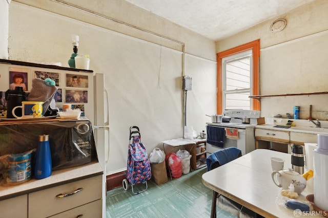 kitchen featuring tile patterned floors and light countertops