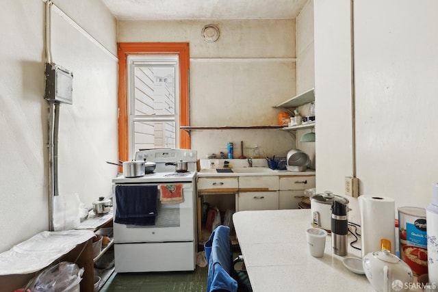 kitchen featuring electric range, light countertops, a sink, and open shelves