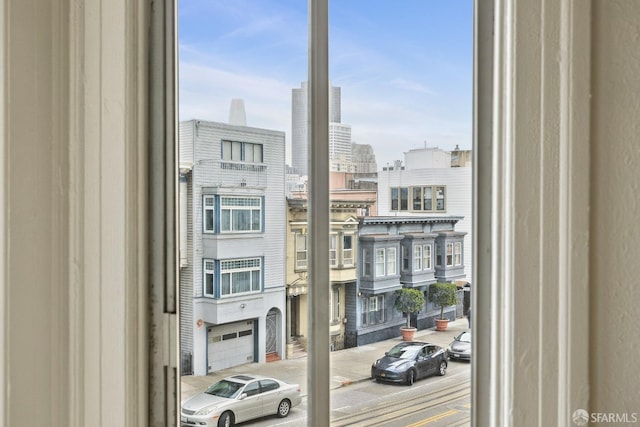 doorway to outside with carpet floors and a view of city