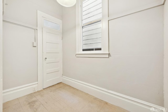 laundry area featuring baseboards