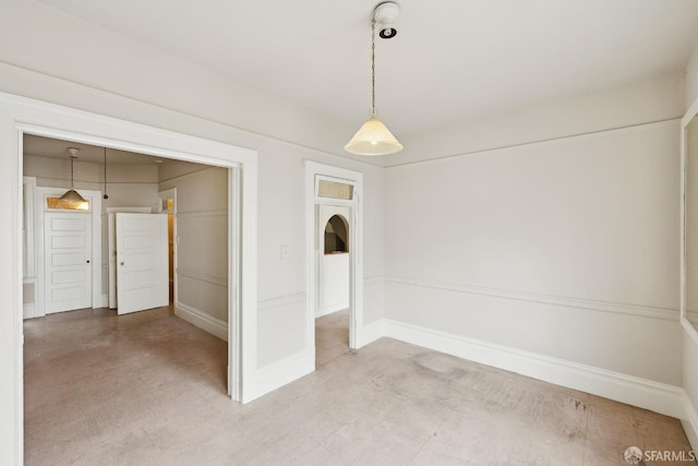 spare room with baseboards