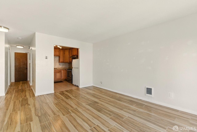 278 7th Ave, San Francisco, CA 94118 - unfurnished living room with light wood-style floors and baseboards
