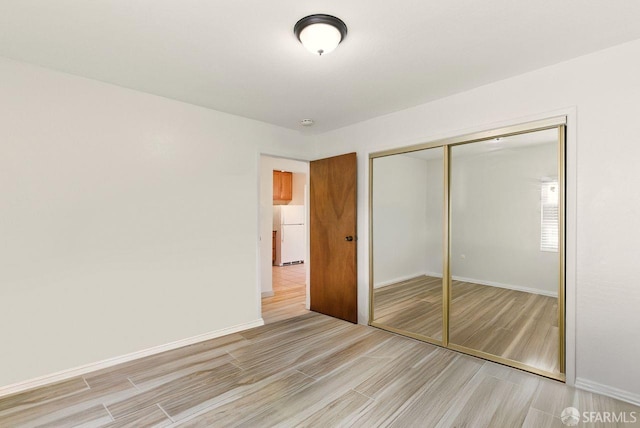 278 7th Ave, San Francisco, CA 94118 - unfurnished bedroom with freestanding refrigerator, wood finished floors, and a closet
