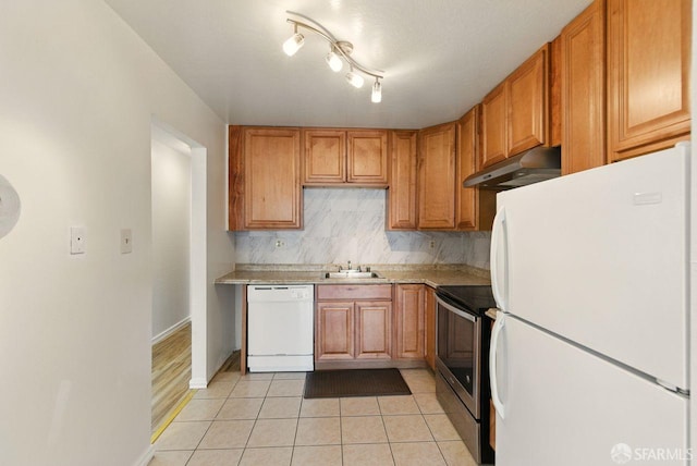 278 7th Ave, San Francisco, CA 94118 - kitchen with white appliances, under cabinet range hood, light countertops, light tile patterned floors, and decorative backsplash