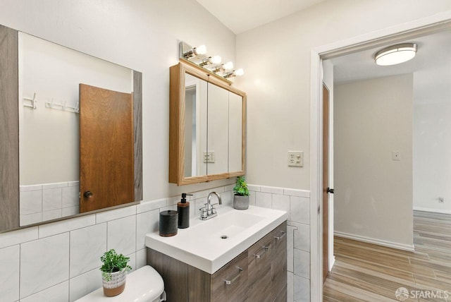 278 7th Ave, San Francisco, CA 94118 - bathroom featuring vanity, wood finished floors, tile walls, and wainscoting