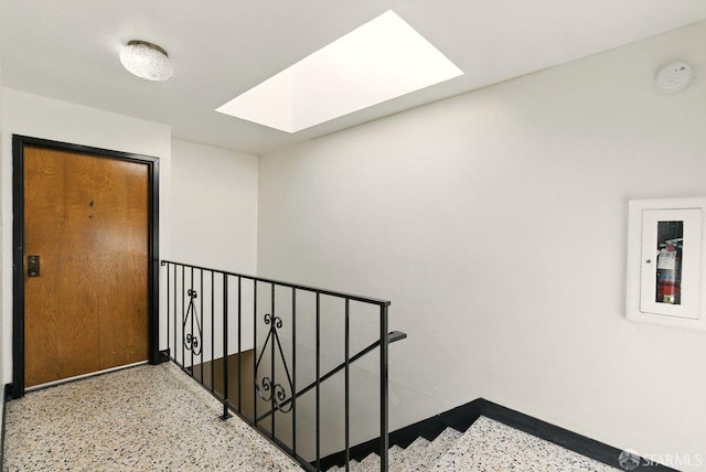278 7th Ave, San Francisco, CA 94118 - hallway featuring speckled floor, a skylight, and an upstairs landing