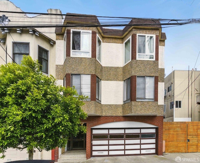 278 7th Ave, San Francisco, CA 94118 - view of front of home featuring an attached garage, stucco siding, driveway, and brick siding