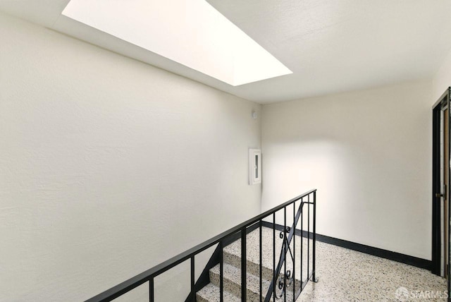 278 7th Ave, San Francisco, CA 94118 - corridor featuring a skylight, dark aggregate flooring, and an upstairs landing