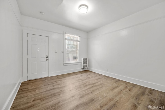 unfurnished room with hardwood / wood-style flooring